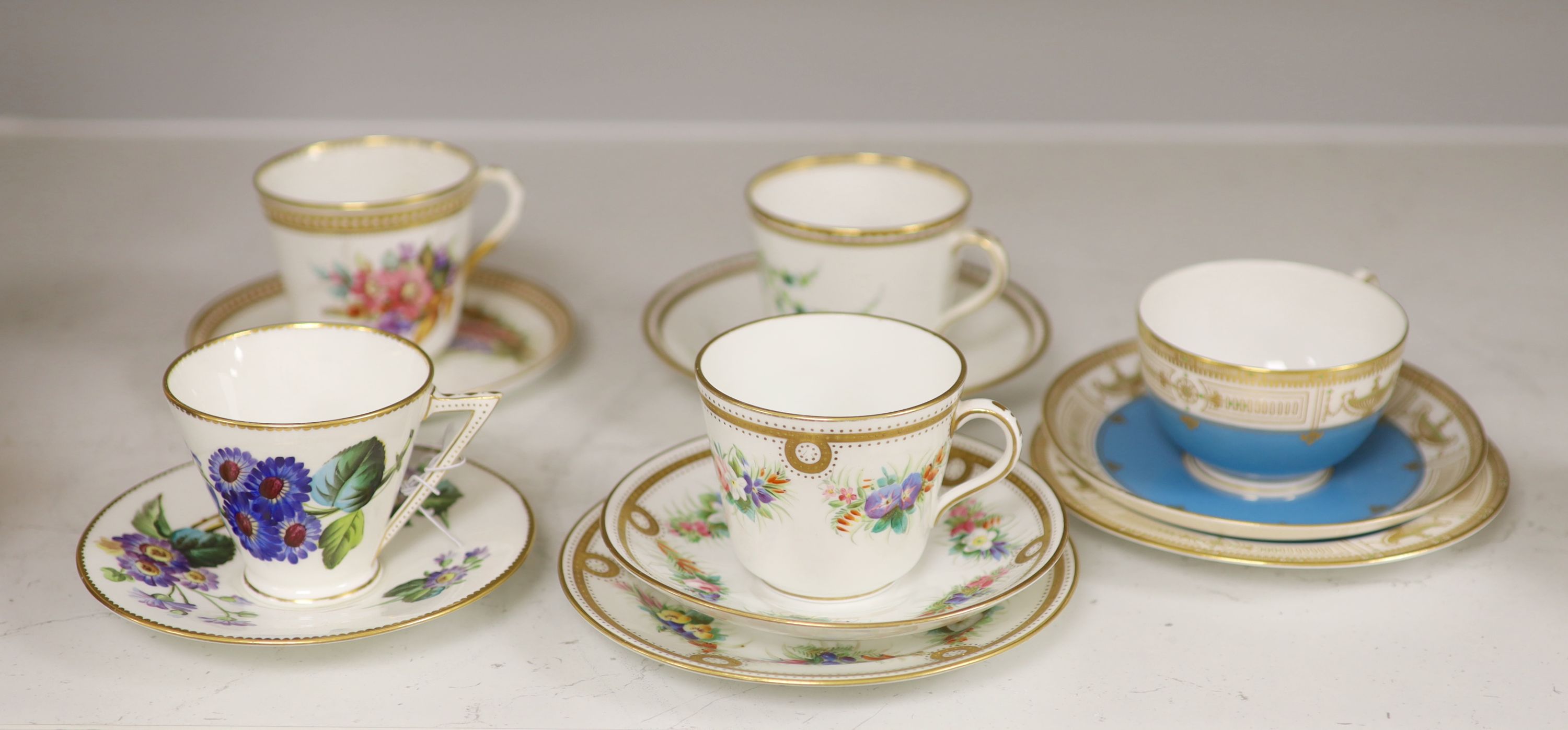 A Royal Worcester jewelled coffee cup and saucer painted with heathers by George Hundley, a Royal Worcester jewelled trio with gilt cla